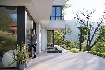 Image showing woman in front of her luxury home villa