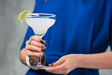 Image showing The exotic cocktail and female hands