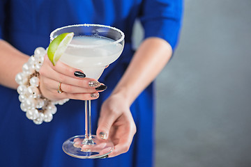 Image showing The exotic cocktail and female hands