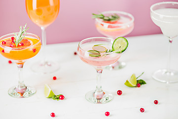 Image showing The rose exotic cocktails and fruits on pink