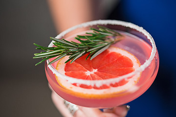 Image showing The exotic cocktail and female hands