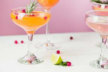 Image showing The rose exotic cocktails and fruits on pink