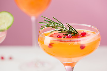 Image showing The rose exotic cocktails and fruits on pink