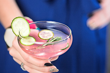 Image showing The exotic cocktail and female hands