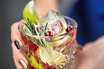 Image showing The exotic cocktail and female hands