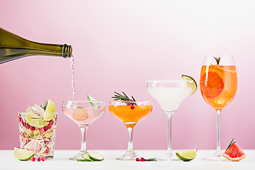 Image showing The rose exotic cocktails and fruits on pink