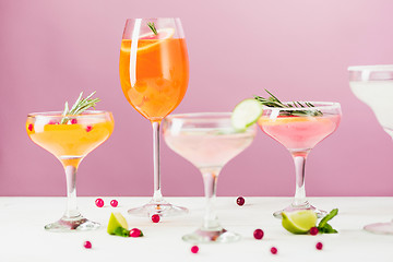 Image showing The rose exotic cocktails and fruits on pink