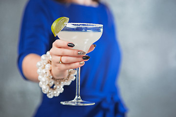 Image showing The exotic cocktail and female hands