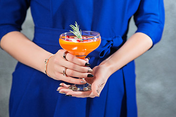 Image showing The exotic cocktail and female hands