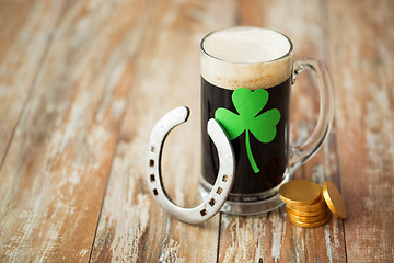 Image showing shamrock on glass of beer, horseshoe and coins