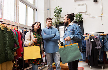 Image showing friends shopping bags at vintage clothing store