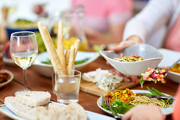 Image showing people putting salad on plate with food