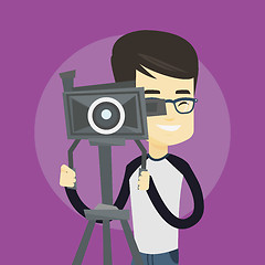 Image showing Cameraman with movie camera on tripod.