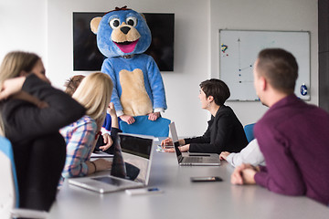 Image showing boss dresed as bear having fun with business people in trendy of