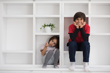 Image showing young boys posing on a shelf