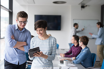 Image showing Two Business People Working With Tablet in office