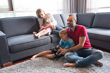 Image showing Happy family playing a video game