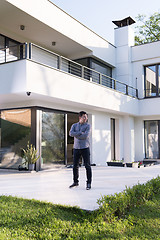 Image showing man in front of his luxury home villa