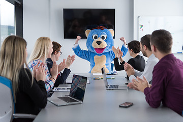 Image showing boss dresed as bear having fun with business people in trendy of