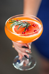 Image showing The exotic cocktail and female hands