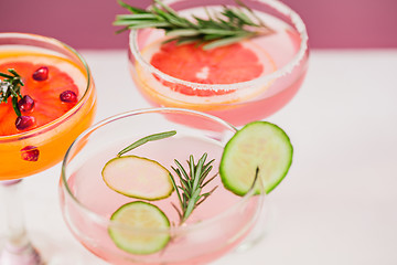 Image showing The rose exotic cocktails and fruits on pink