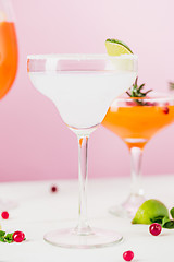 Image showing The rose exotic cocktails and fruits on pink