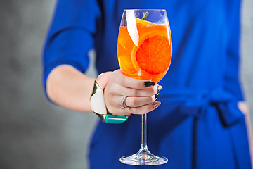 Image showing The exotic cocktail and female hands