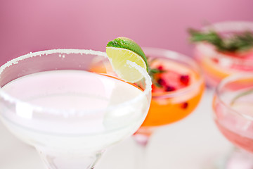 Image showing The rose exotic cocktails and fruits on pink