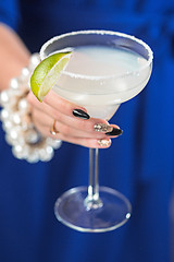 Image showing The exotic cocktail and female hands