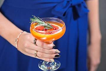 Image showing The exotic cocktail and female hands