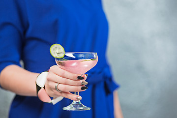 Image showing The exotic cocktail and female hands