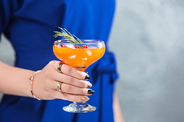 Image showing The exotic cocktail and female hands