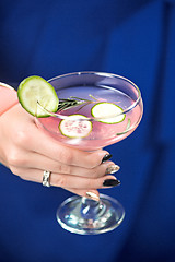 Image showing The exotic cocktail and female hands