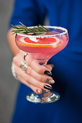 Image showing The exotic cocktail and female hands