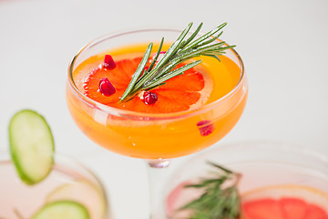 Image showing The rose exotic cocktails and fruits on pink