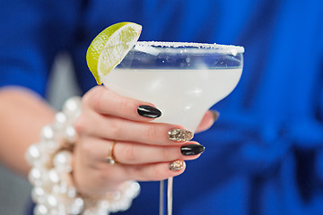 Image showing The exotic cocktail and female hands