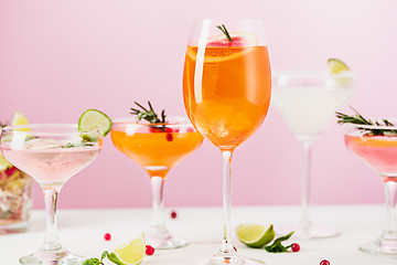 Image showing The rose exotic cocktails and fruits on pink