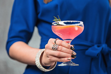 Image showing The exotic cocktail and female hands