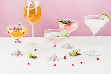 Image showing The rose exotic cocktails and fruits on pink