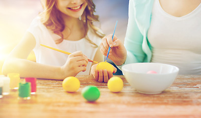 Image showing daughter and mother coloring easter eggs