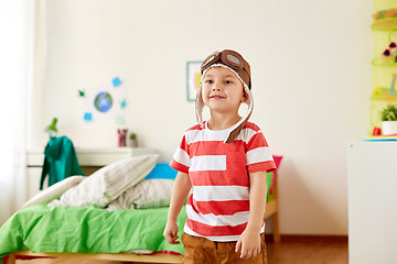 Image showing happy little boy in pilot hat playing at home