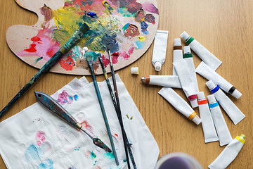 Image showing palette knife, brushes and paint tubes on table