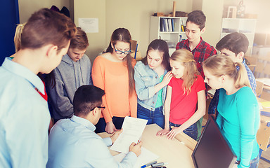 Image showing group of students and teacher with tests at school