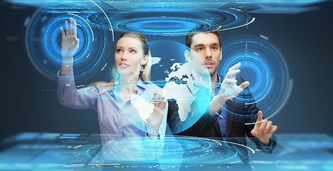 Image showing businessman and businesswoman with virtual earth