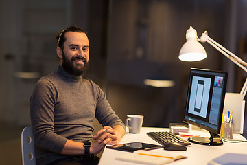 Image showing creative man or designer with computer at office