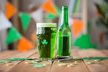 Image showing glass of green beer with shamrock and horseshoe