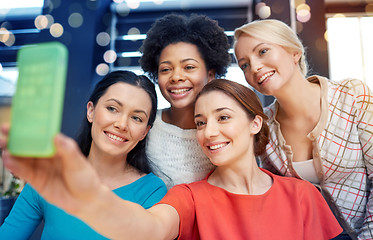 Image showing happy young women taking selfie with smartphone