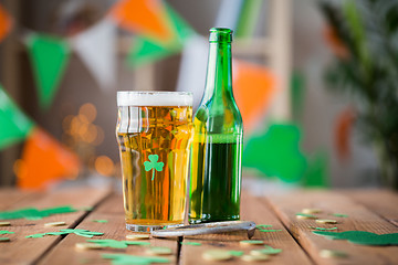 Image showing glass of green beer, horseshoe and gold coins