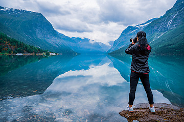 Image showing Nature photographer tourist with camera shoots lovatnet lake Bea