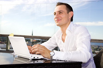 Image showing businessman on leisure with laptop